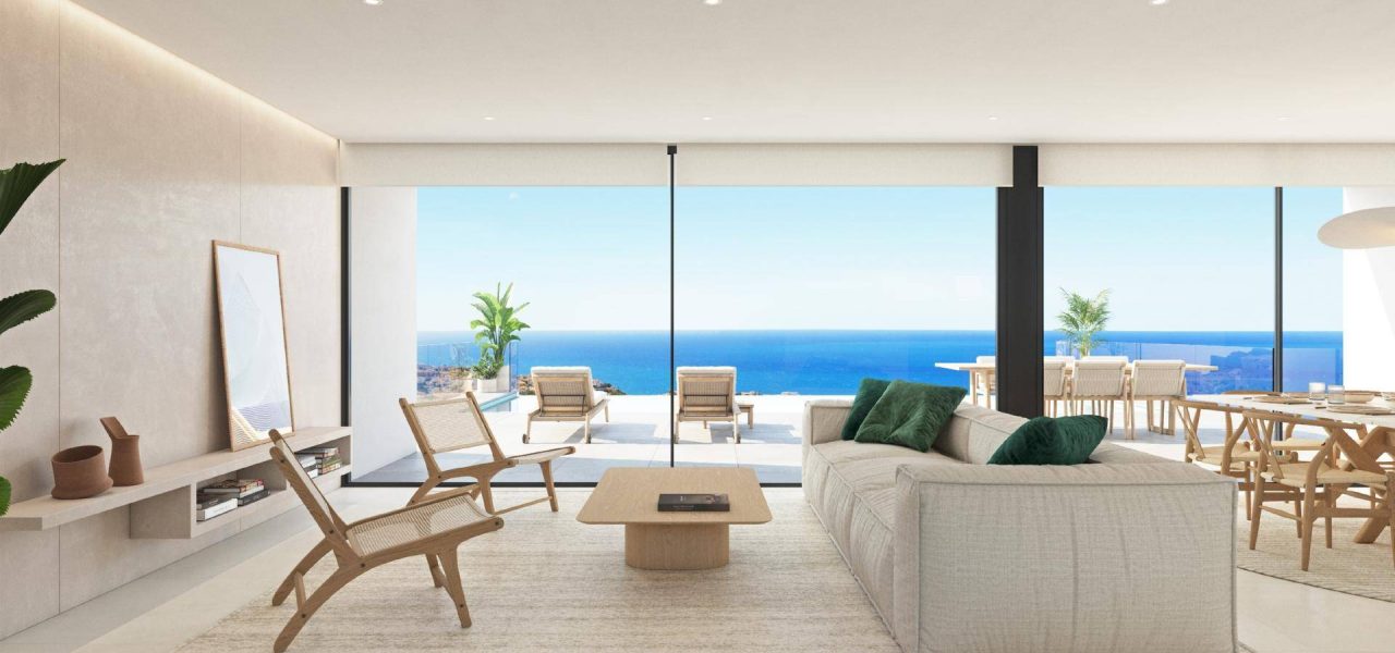 a living room with a large glass wall and a couch and chairs